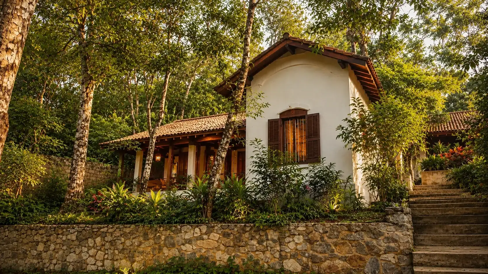 Villa Three's colonial exterior nestled among rubber trees at golden hour