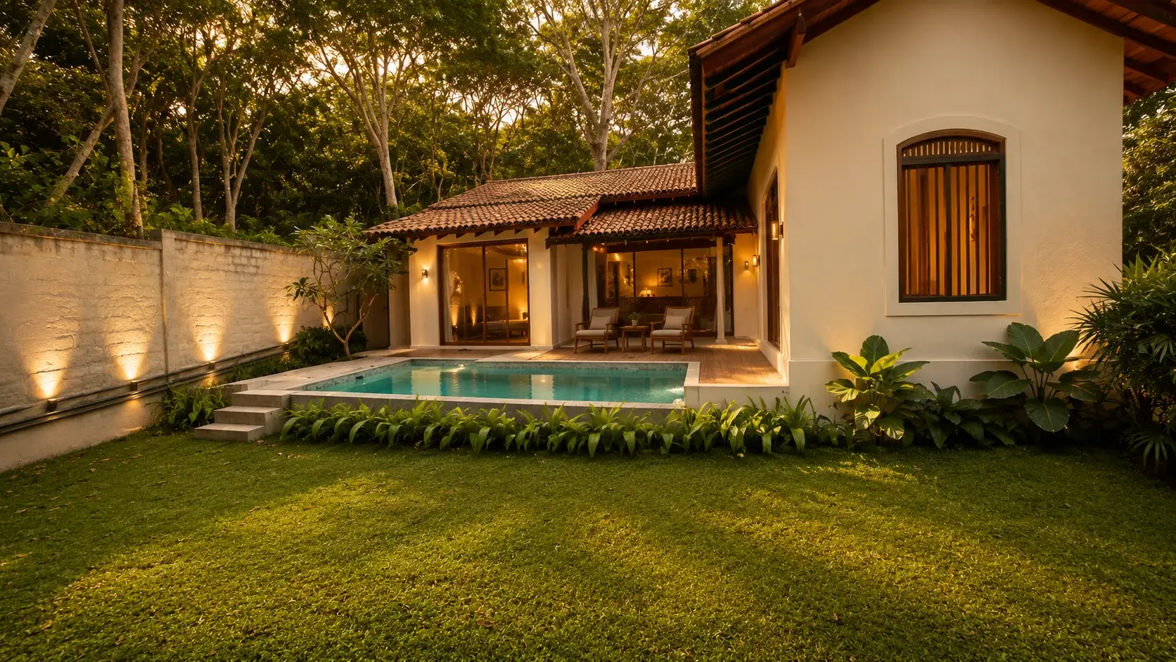 Villa Two's colonial exterior and private pool lit at dusk